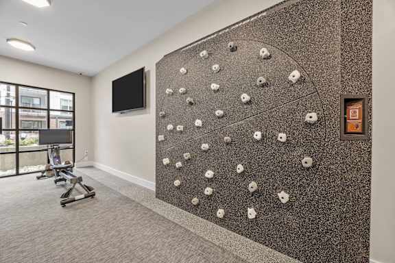 A wall with a climbing wall in the middle of a room.at Adler Montford Park + Drexel Townes, North Carolina, 28209