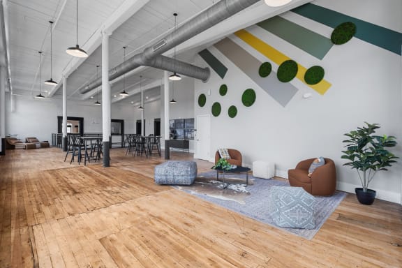 a living room with wood floors and white walls and chairs and couches at Spinning Mill Lofts, North Carolina, 27520