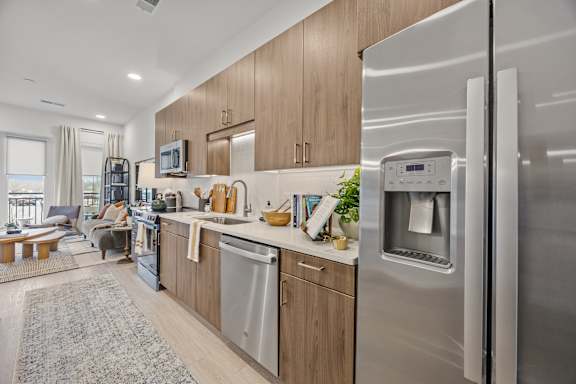 A modern kitchen with a refrigerator, dishwasher, and oven.