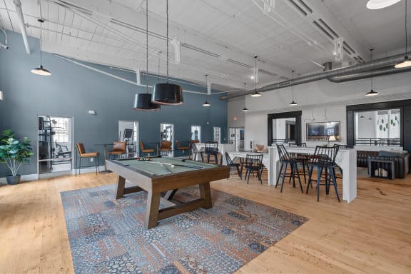 a game room with a pool table and tables at Spinning Mill Lofts, Clayton