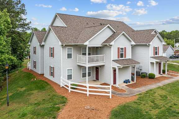 a large white house with a porch and a deck