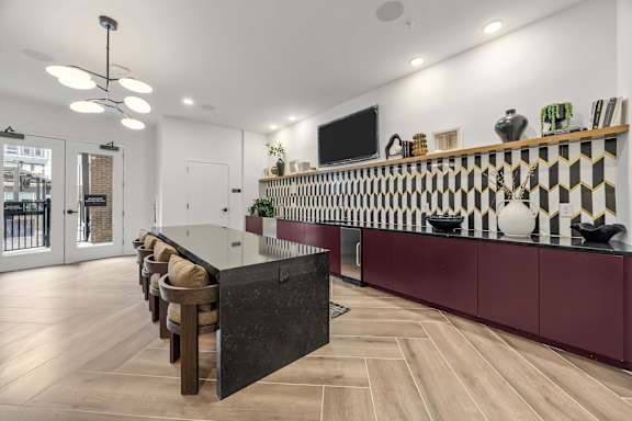 A modern kitchen with a black and white checkered backsplash.at Adler Montford Park + Drexel Townes, North Carolina, 28209
