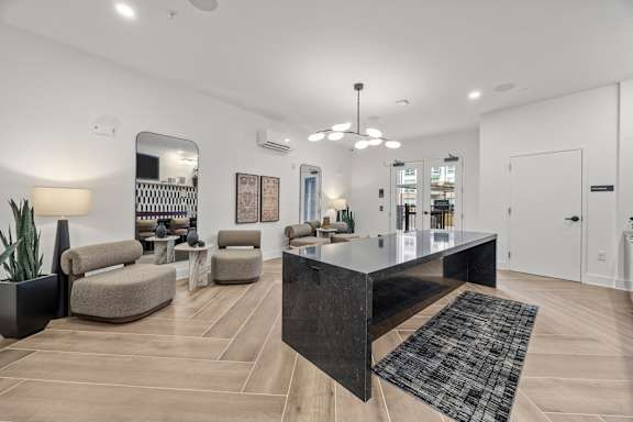 A modern living room with a large island in the middle.at Adler Montford Park + Drexel Townes, North Carolina, 28209