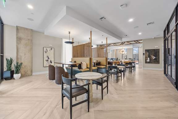 A modern dining room with a long table and chairs.at Adler Montford Park + Drexel Townes, North Carolina, 28209