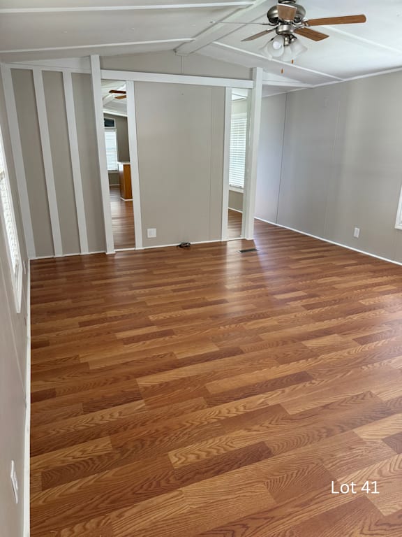 A room with wooden flooring and a ceiling fan.