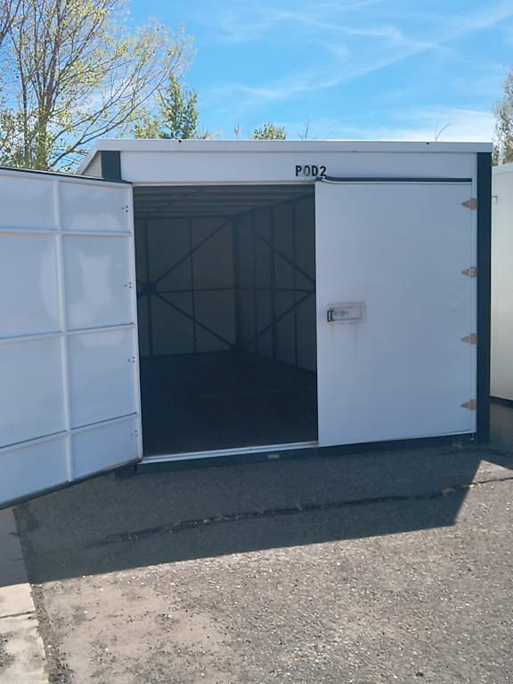 A white container with the label "POD2" is open, revealing a dark interior.