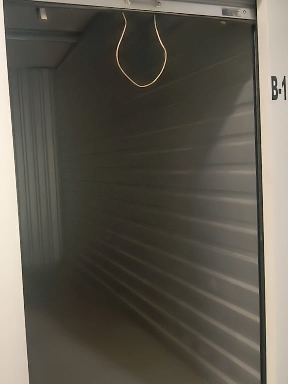 A metal shelving unit with a wire hanging from the top.