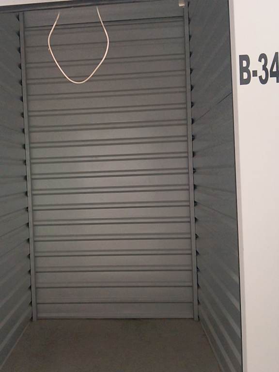 A white door with a number B-34 on the wall.