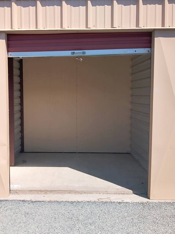A closed garage door with a red roller.