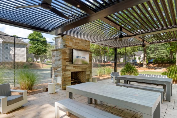 the preserve at ballantyne commons courtyard with picnic tables and a stone fireplace