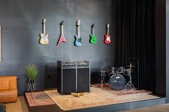 Music room with electric guitars and drum set at AMP 30 Apartments, San Diego, CA 92116