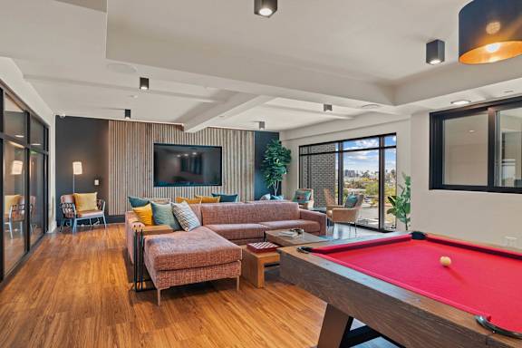 Recreation room with pool table and lounge seating at AMP 30 Apartments, California, 92116