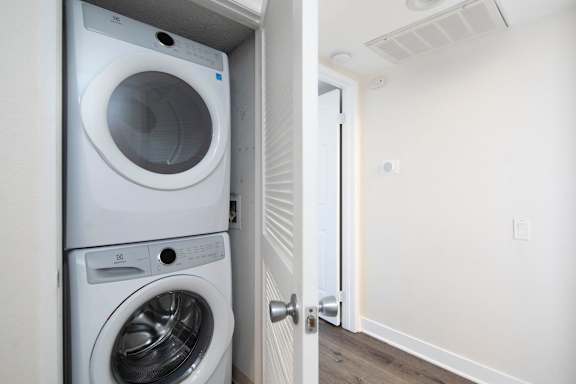 A white washing machine and dryer in a small laundry room.