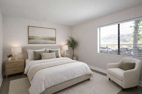 A bedroom with a large bed, a chair, and a painting on the wall.