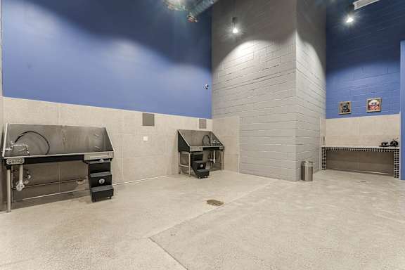 Outdoor grilling area with large bbq smokers at AMP 30 Apartments, California