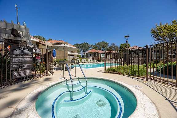 Hot tub with handrail near swimming pool at Bella Del Mar Apartments, Del Mar, California