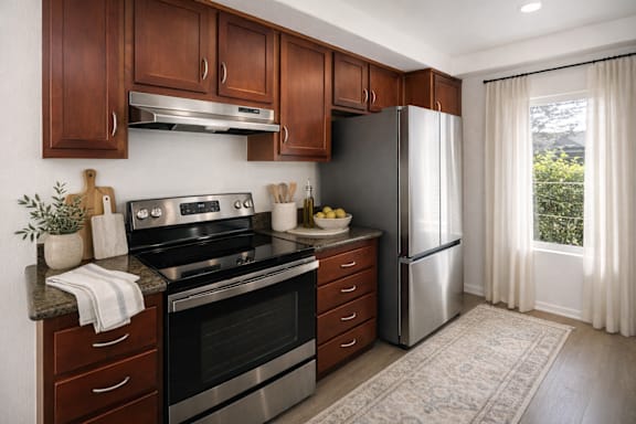 A modern kitchen with wooden cabinets and stainless steel appliances.