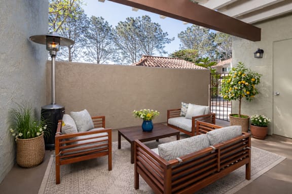 A patio with a table and chairs and a lamp.
