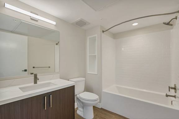 A white toilet sits next to a sink in a bathroom.