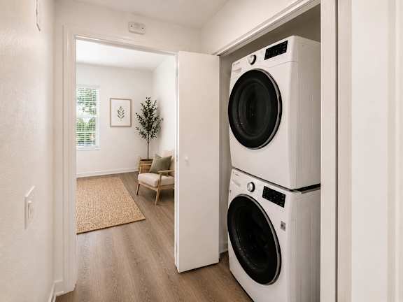 A white washing machine is in a doorway.