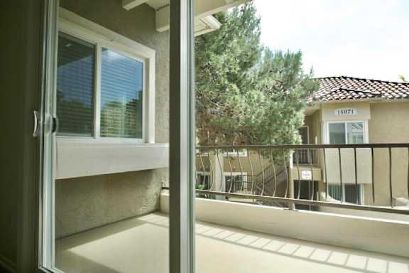 A balcony with a view of a building with the number 14071 on it.