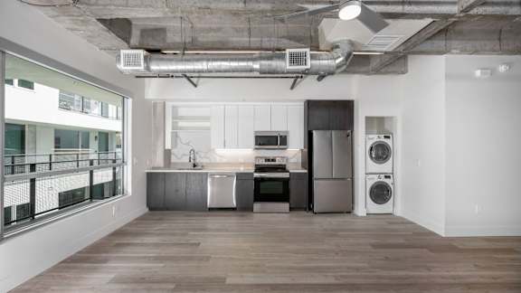 Open kitchen with stacked washer/dryer