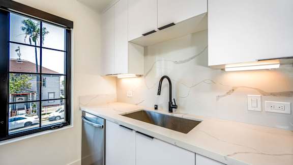White kitchen with dark faucet