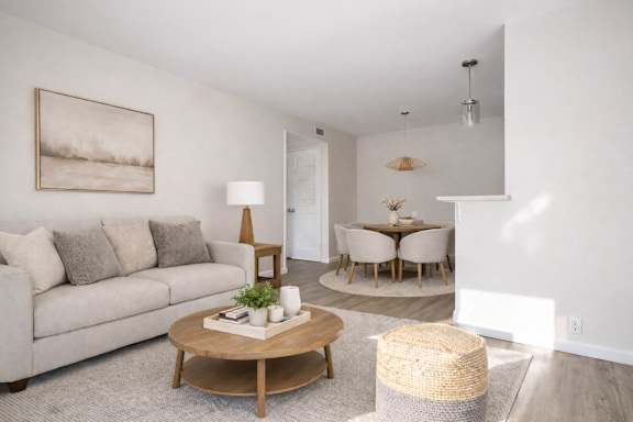 A living room with a couch, coffee table, and lamp.