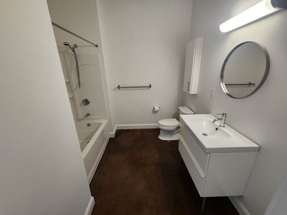 Bathroom with white vanity and tub shower combo at 68 Beale Apartments, Massachusetts, 02169