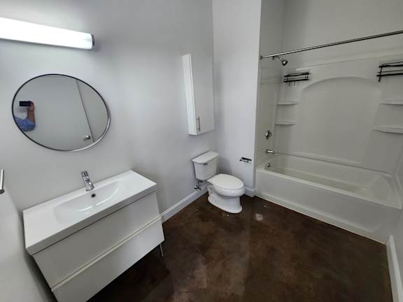 A bathroom with a sink, toilet and bathtub.