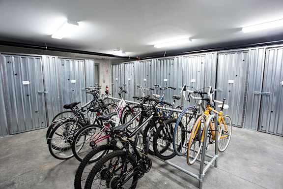 A bike rack full of bicycles in a garage.