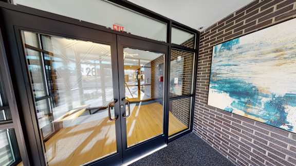A glass door with a handle and a sign above it that says "EXIT".