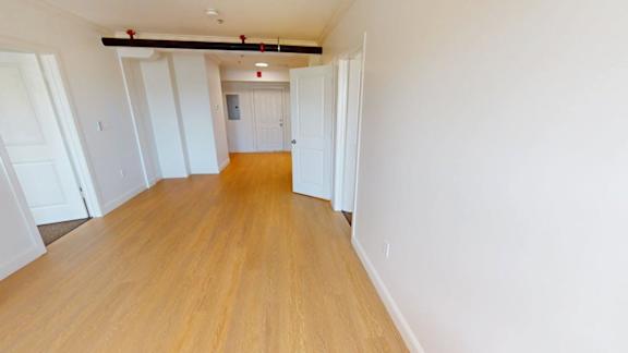 Empty apartment interior with hardwood flooring at Bostonian Shoe Lofts Apartments, Whitman, Massachusetts