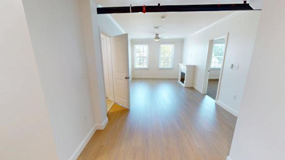 Bright living area with fireplace and wood flooring at Bostonian Shoe Lofts Apartments, Massachusetts