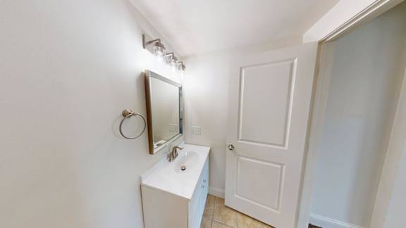 Bathroom vanity with mirror and towel ring at Bostonian Shoe Lofts Apartments, Massachusetts, 02382