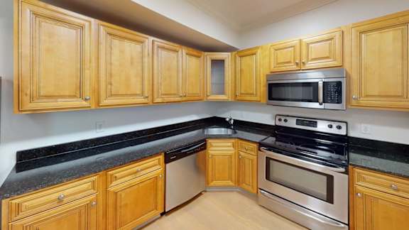 Kitchen with granite countertops and stainless steel appliances at Bostonian Shoe Lofts Apartments, Massachusetts, 02382