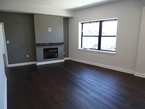 A room with a fireplace and a window.