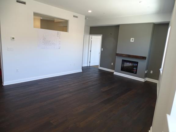 A room with a fireplace and a drawing on the wall.