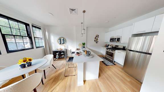 A modern kitchen with a dining table and chairs.