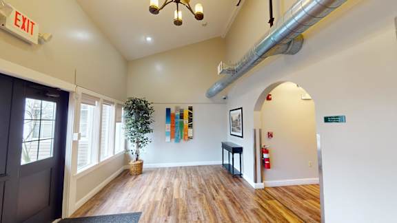 Bright entrance hallway with vaulted ceilings and archway at Bostonian Shoe Lofts Apartments, Whitman, Massachusetts