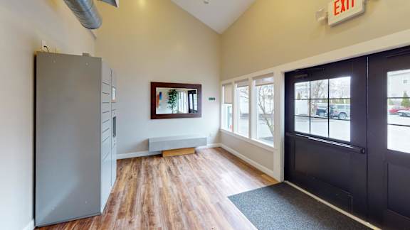 Lobby area with mailboxes and bench seating at Bostonian Shoe Lofts Apartments, Massachusetts, 02382