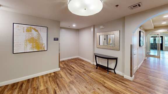 Hallway with artwork and console table at Bostonian Shoe Lofts Apartments, Whitman, MA