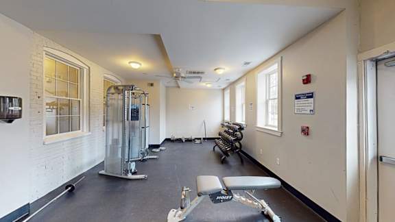 Fitness center with cable machine and free weights at Bostonian Shoe Lofts Apartments, Whitman, MA 02382