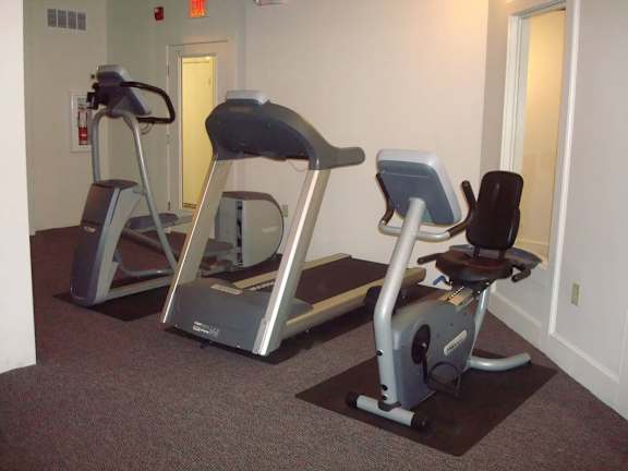 Two exercise bikes are in a room.