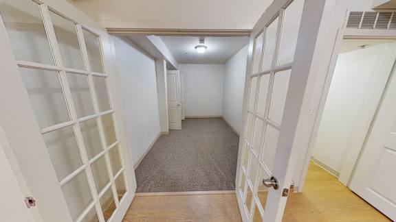 Hallway with french doors and built in shelving at Bostonian Shoe Lofts Apartments, Whitman, Massachusetts