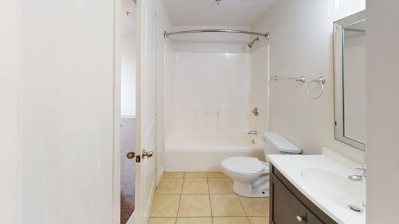Bathroom with tub shower combo and modern vanity at Bostonian Shoe Lofts Apartments, Massachusetts, 02382