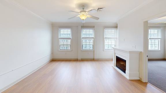 Spacious room with fireplace and three large windows at Bostonian Shoe Lofts Apartments, Whitman