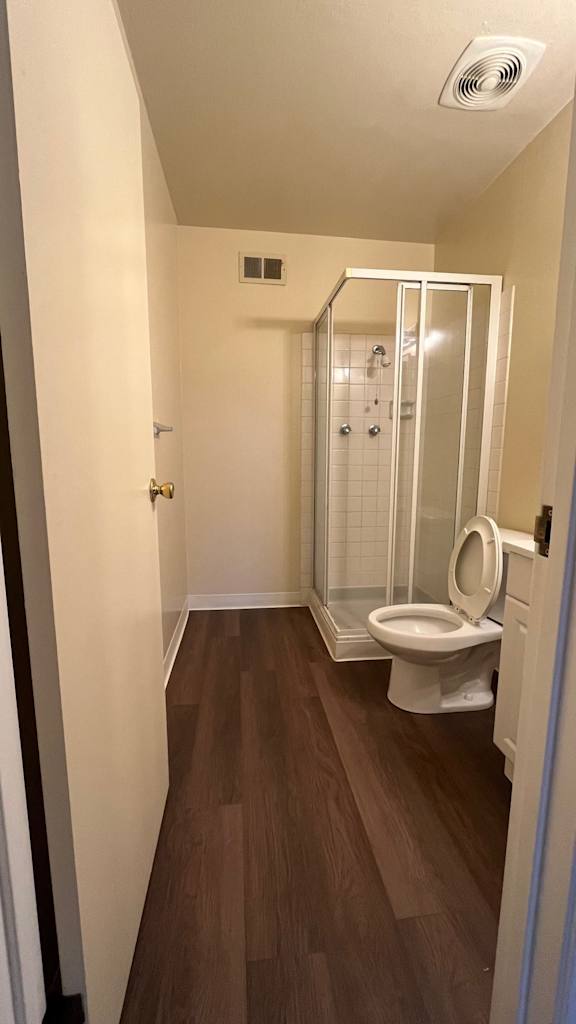 Small bathroom with a toilet and a walk-in shower at Vacaville Park Apartments, Vacaville, CA, 95687