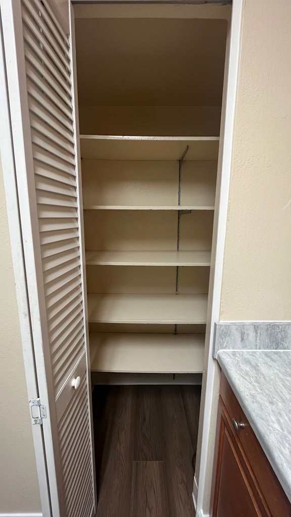 White pantry with shelves and a white counter at Vacaville Park Apartments, Vacaville, California