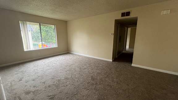 Room with a carpeted floor and window at Vacaville Park Apartments, Vacaville, CA, California , 95687